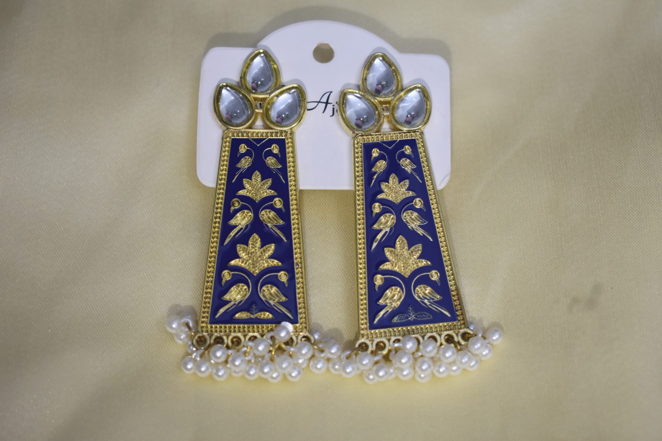 Elegant blue and gold Indian earrings with intricate bird and floral designs, adorned with pearls and sparkling stones, perfect for festive and ethnic wear.
